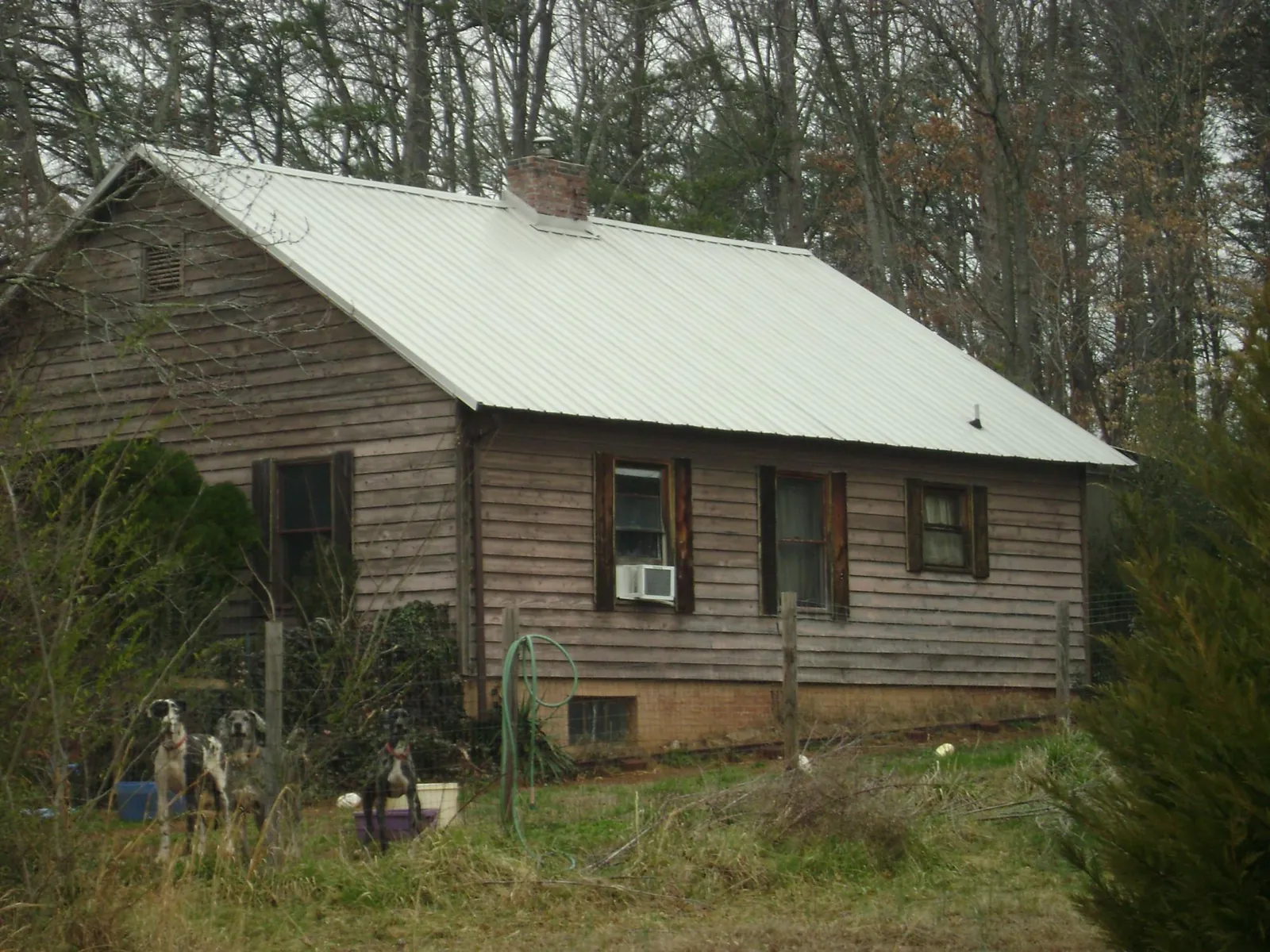 White metal roof on an old wood sided farmhouse, from a Metal Roof Installation job in Owensville